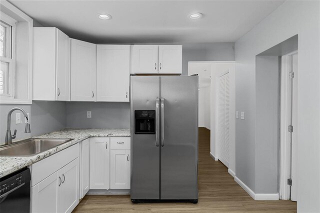 5337 Arsenal St, Saint Louis, MO 63139 - kitchen featuring stainless steel fridge, a sink, black dishwasher, white cabinetry, and light wood-type flooring