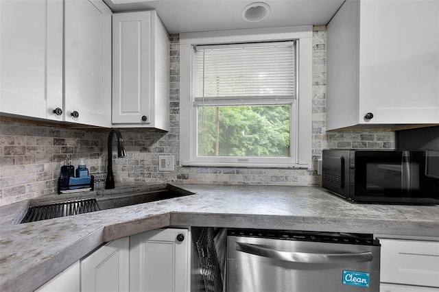 11454 State Highway 72, Millersville, MO 63766 - kitchen featuring dishwasher, black microwave, a sink, white cabinets, and decorative backsplash