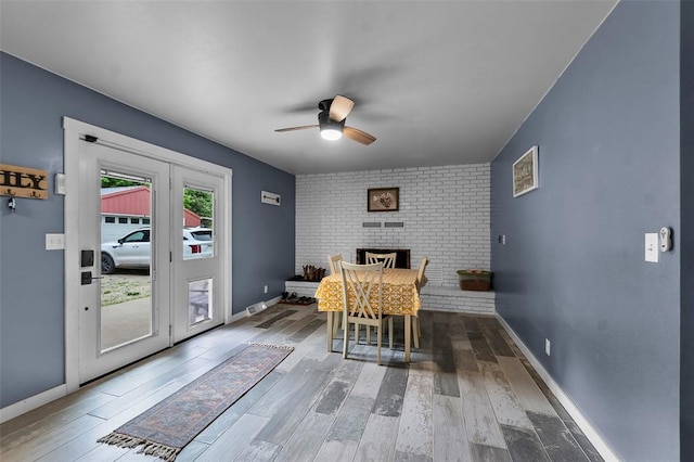 11454 State Highway 72, Millersville, MO 63766 - dining area with ceiling fan, wood finished floors, baseboards, and a fireplace