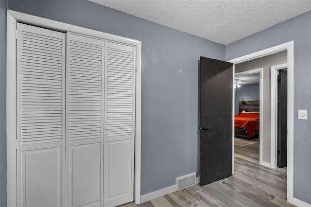 11454 State Highway 72, Millersville, MO 63766 - hall featuring light wood-style flooring, a textured ceiling, and baseboards
