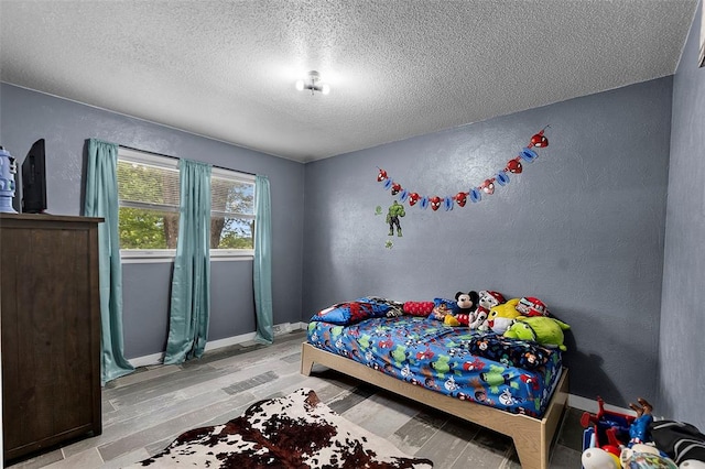 11454 State Highway 72, Millersville, MO 63766 - bedroom with a textured ceiling, light wood-type flooring, a textured wall, and baseboards