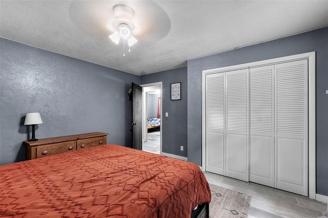 11454 State Highway 72, Millersville, MO 63766 - bedroom with light wood finished floors, a ceiling fan, a closet, baseboards, and a textured wall