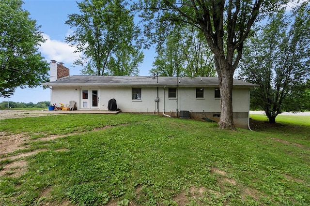 11454 State Highway 72, Millersville, MO 63766 - back of property with central AC, a chimney, a lawn, and a patio area