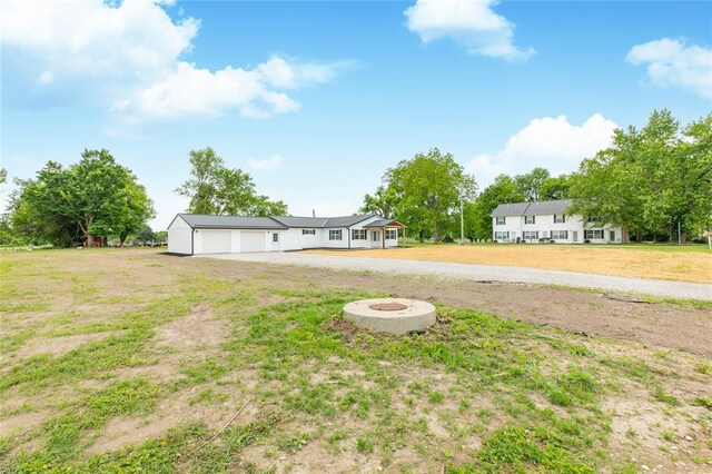 702 E Warren St, Bunker Hill, IL 62014 - view of grassy yard with a garage and driveway