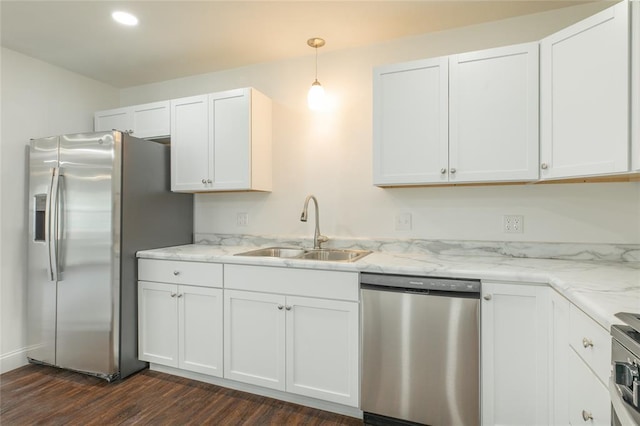 702 E Warren St, Bunker Hill, IL 62014 - kitchen with stainless steel appliances, a sink, dark wood-style flooring, white cabinetry, and light stone counters