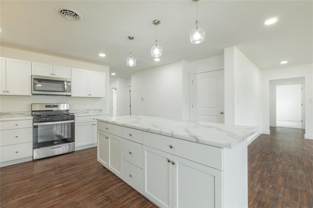 702 E Warren St, Bunker Hill, IL 62014 - kitchen featuring stainless steel appliances, recessed lighting, dark wood finished floors, a center island, and white cabinets