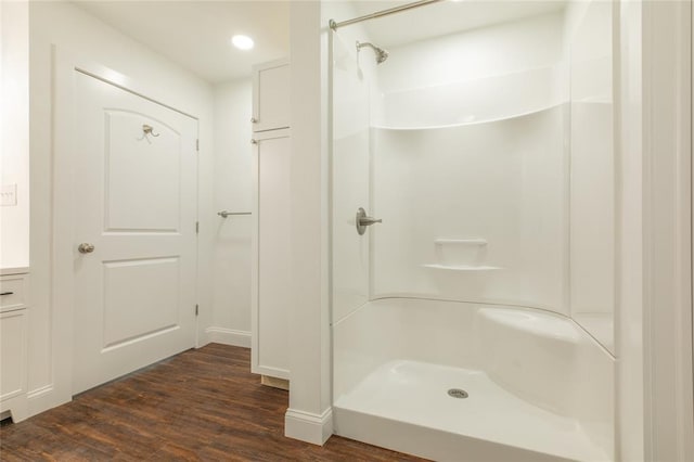 702 E Warren St, Bunker Hill, IL 62014 - bathroom with wood finished floors, a shower, recessed lighting, and baseboards
