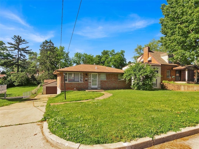 8668 Engler Ave, St John, MO 63114 - view of front of home featuring a detached garage, brick siding, a front yard, and an outbuilding