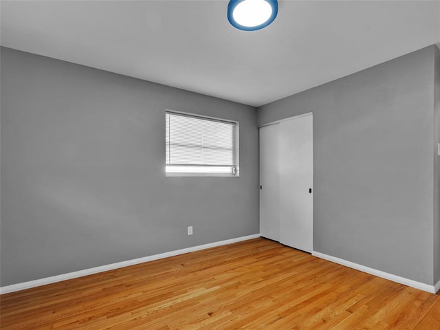 8668 Engler Ave, St John, MO 63114 - unfurnished bedroom featuring wood finished floors, a closet, and baseboards