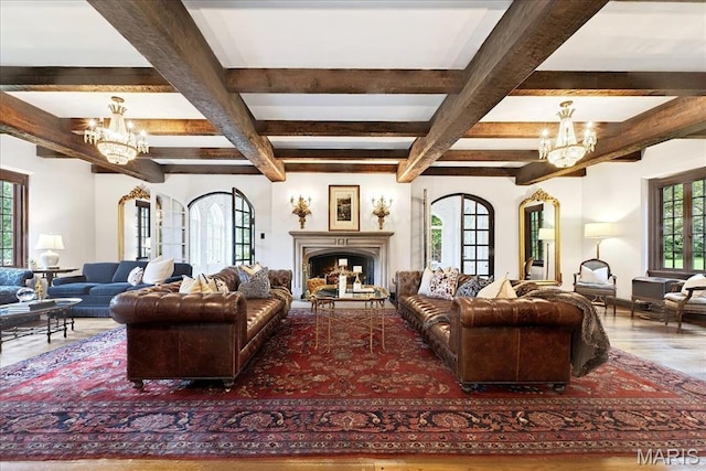 32 Woodoaks Trl, Ladue, MO 63124 - living room with a chandelier, wood finished floors, beamed ceiling, and a fireplace