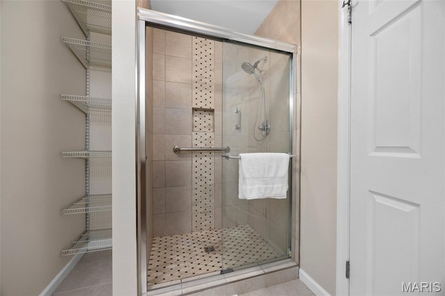 4163 Attleboro Ct, Saint Charles, MO 63304 - bathroom featuring a stall shower, baseboards, and tile patterned flooring