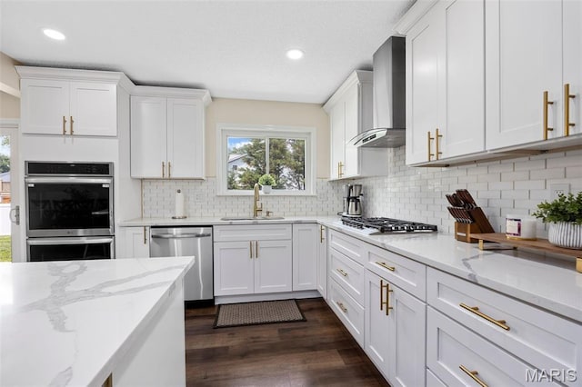 4163 Attleboro Ct, Saint Charles, MO 63304 - kitchen with stainless steel appliances, wall chimney range hood, a sink, healthy amount of natural light, and recessed lighting