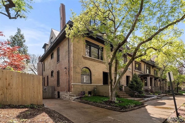 232 N Newstead Ave, Saint Louis, MO 63108 - view of home's exterior featuring brick siding and a chimney