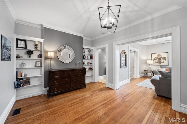 232 N Newstead Ave, Saint Louis, MO 63108 - entryway with ornamental molding, hardwood / wood-style flooring, a chandelier, and baseboards