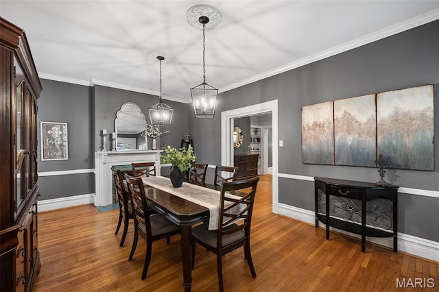 232 N Newstead Ave, Saint Louis, MO 63108 - dining area featuring wood finished floors, a chandelier, baseboards, and ornamental molding