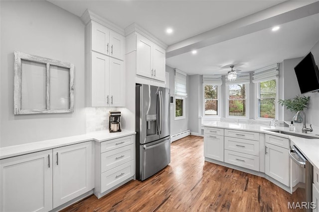 232 N Newstead Ave, Saint Louis, MO 63108 - kitchen with stainless steel appliances, a baseboard heating unit, a sink, white cabinetry, and ceiling fan