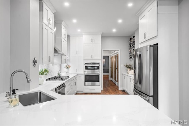 232 N Newstead Ave, Saint Louis, MO 63108 - kitchen featuring stainless steel appliances, a sink, recessed lighting, decorative backsplash, and white cabinetry