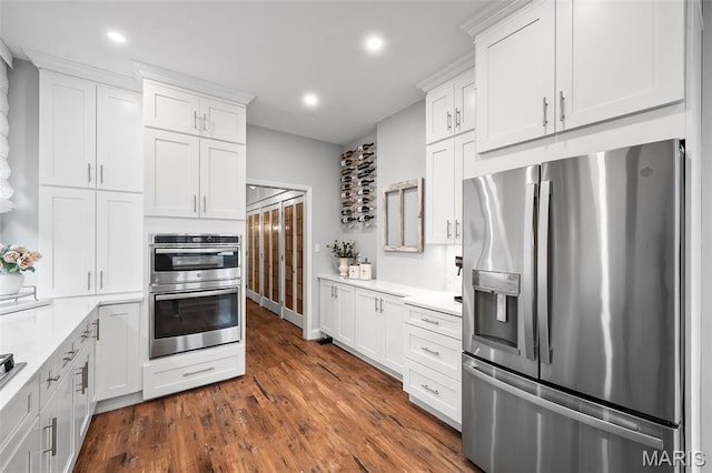 232 N Newstead Ave, Saint Louis, MO 63108 - kitchen featuring appliances with stainless steel finishes, light countertops, white cabinets, recessed lighting, and dark wood finished floors