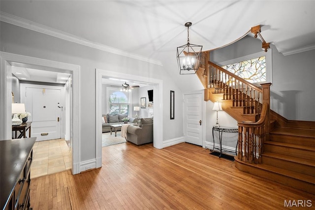 232 N Newstead Ave, Saint Louis, MO 63108 - staircase featuring hardwood / wood-style floors, ornamental molding, baseboards, a chandelier, and ceiling fan