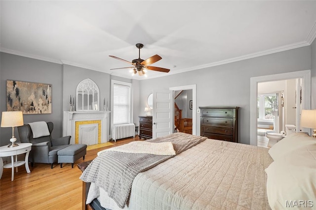 232 N Newstead Ave, Saint Louis, MO 63108 - bedroom with radiator, ornamental molding, light wood finished floors, ensuite bath, and a ceiling fan