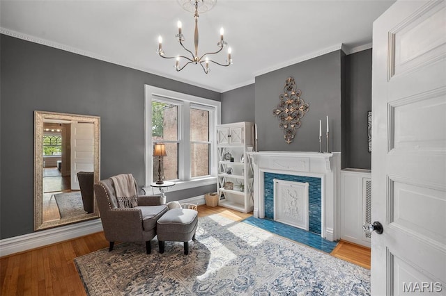 232 N Newstead Ave, Saint Louis, MO 63108 - sitting room featuring a chandelier, wood finished floors, a high end fireplace, crown molding, and baseboards