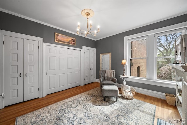 232 N Newstead Ave, Saint Louis, MO 63108 - sitting room with a chandelier, wood finished floors, crown molding, and baseboards