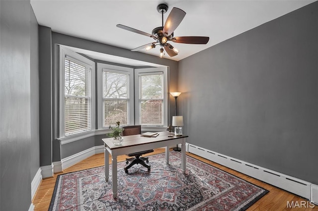 232 N Newstead Ave, Saint Louis, MO 63108 - home office featuring baseboard heating, ceiling fan, light wood-type flooring, and baseboards