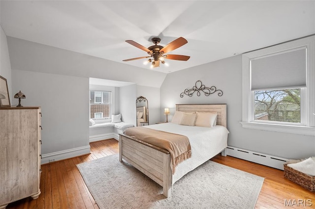 232 N Newstead Ave, Saint Louis, MO 63108 - bedroom featuring baseboard heating, hardwood / wood-style floors, vaulted ceiling, ceiling fan, and baseboards