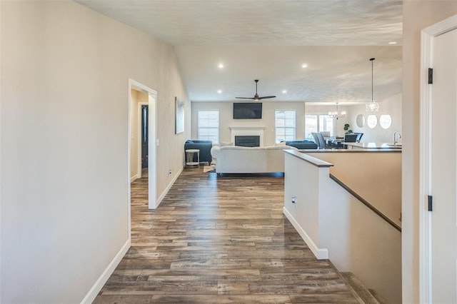 3772 Osprey Ct, Shiloh, IL 62221 - corridor featuring dark wood-style floors, healthy amount of natural light, baseboards, a chandelier, and recessed lighting