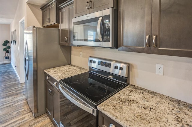 3772 Osprey Ct, Shiloh, IL 62221 - kitchen featuring stainless steel appliances, light wood finished floors, dark brown cabinetry, and light stone countertops