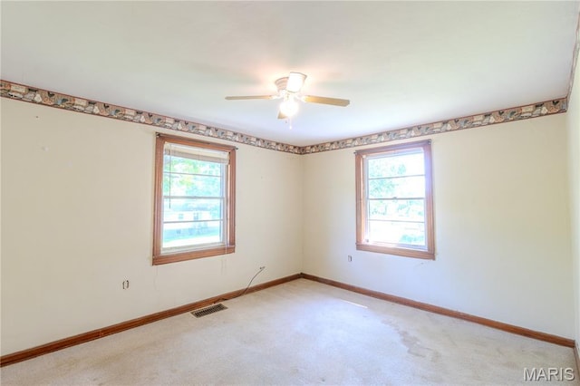 504 N Pine St, Richland, MO 65556 - unfurnished room featuring plenty of natural light, light carpet, and ceiling fan