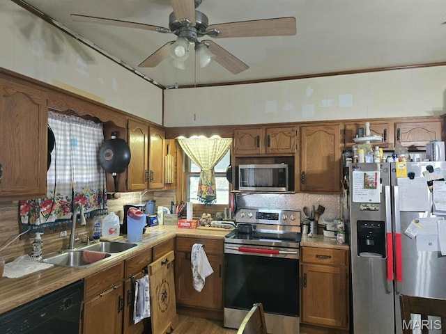 346 S Locust St, Dexter, MO 63841 - kitchen with stainless steel appliances, a sink, a ceiling fan, light countertops, and brown cabinetry