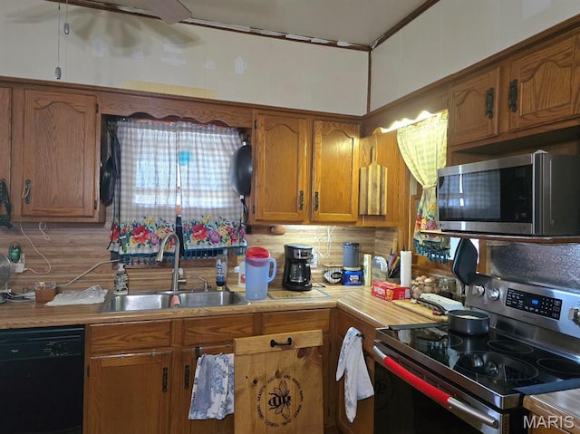346 S Locust St, Dexter, MO 63841 - kitchen with appliances with stainless steel finishes, a sink, brown cabinets, backsplash, and light countertops