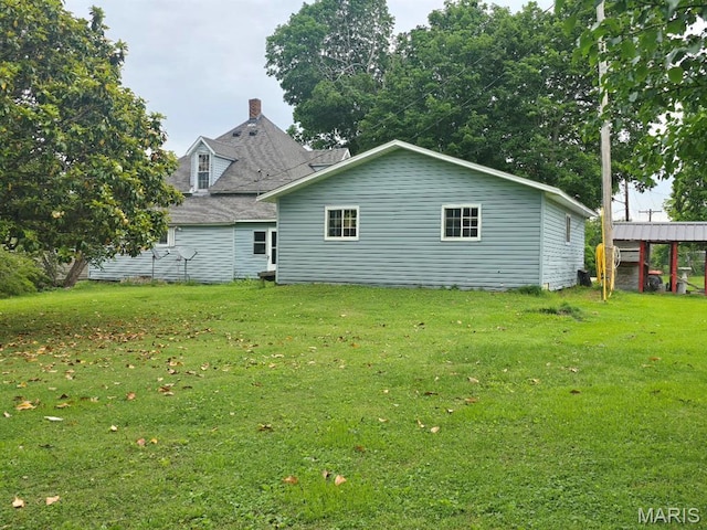 346 S Locust St, Dexter, MO 63841 - rear view of house featuring a lawn and a chimney
