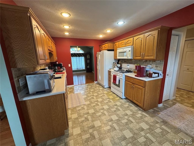 8847 State Route 14th Hwy, Duquoin, IL 62832 - kitchen with white appliances, decorative backsplash, light countertops, recessed lighting, and a textured ceiling