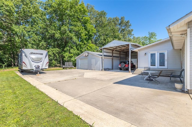 2865 Vaughn Ave, Poplar Bluff, MO 63901 - view of patio featuring a carport, an outdoor structure, and concrete driveway