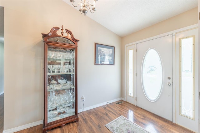 2865 Vaughn Ave, Poplar Bluff, MO 63901 - foyer entrance featuring lofted ceiling, wood finished floors, a chandelier, and baseboards