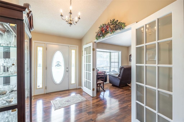 2865 Vaughn Ave, Poplar Bluff, MO 63901 - entrance foyer with a chandelier, lofted ceiling, wood finished floors, french doors, and a textured ceiling