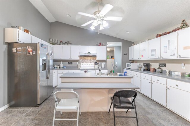 2865 Vaughn Ave, Poplar Bluff, MO 63901 - kitchen with stainless steel fridge with ice dispenser, electric stove, white microwave, under cabinet range hood, and a sink