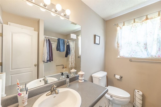 2865 Vaughn Ave, Poplar Bluff, MO 63901 - full bathroom featuring vanity, toilet, and a textured ceiling