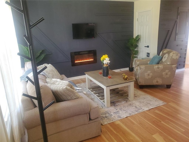 1 Wild Deer Ln, Saint Peters, MO 63376 - living room featuring wood finished floors and a glass covered fireplace