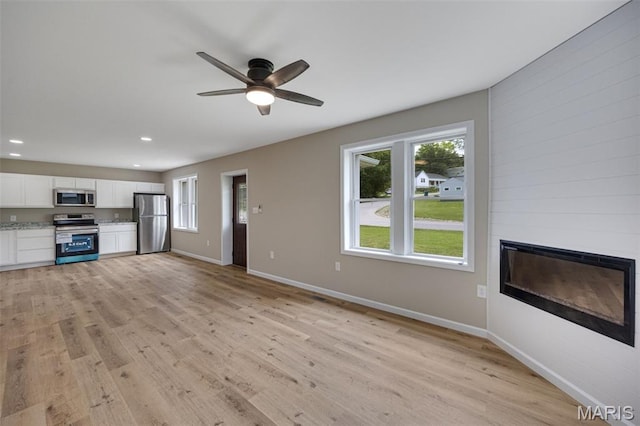 812 Richeson Rd, Potosi, MO 63664 - unfurnished living room with a large fireplace, healthy amount of natural light, light wood-style floors, and recessed lighting