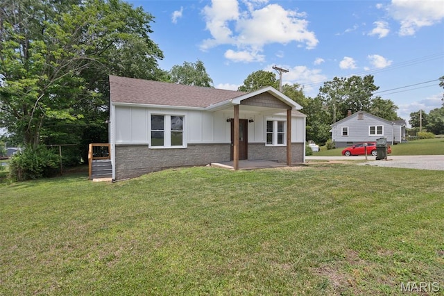 812 Richeson Rd, Potosi, MO 63664 - view of front facade featuring board and batten siding, a front yard, and roof with shingles
