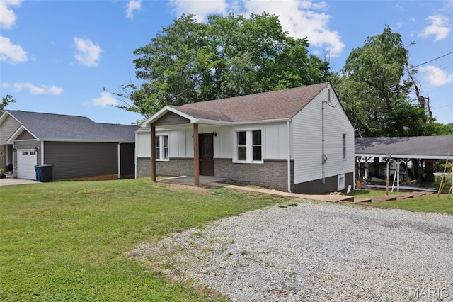 812 Richeson Rd, Potosi, MO 63664 - ranch-style house with board and batten siding, a front yard, a garage, and gravel driveway