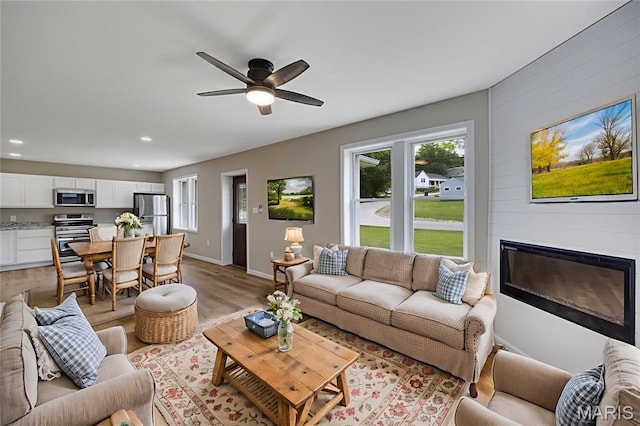 812 Richeson Rd, Potosi, MO 63664 - living area featuring plenty of natural light, light wood finished floors, a glass covered fireplace, recessed lighting, and a ceiling fan
