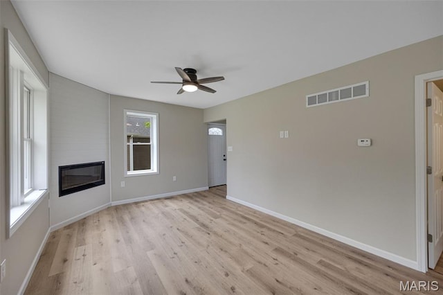 812 Richeson Rd, Potosi, MO 63664 - unfurnished living room with light wood-type flooring, ceiling fan, and a fireplace
