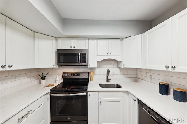 8854 Flamingo Ct, Saint Louis, MO 63144 - kitchen featuring stainless steel microwave, electric range, a sink, and white cabinetry