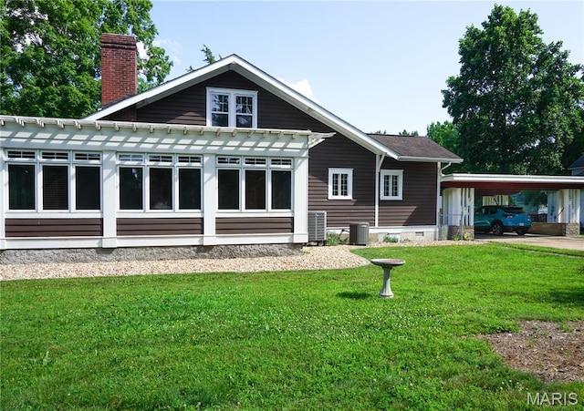 301 S Meramec St, St James, MO 65559 - rear view of property with a chimney, a lawn, an attached carport, and crawl space