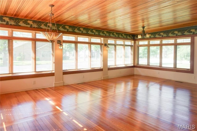 301 S Meramec St, St James, MO 65559 - unfurnished sunroom with a chandelier, wallpapered walls, and wood finished floors