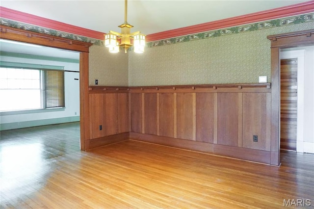 301 S Meramec St, St James, MO 65559 - unfurnished room with wood finished floors, wainscoting, wallpapered walls, and a chandelier